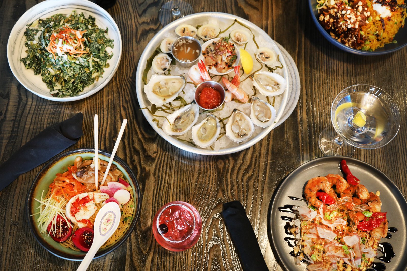 table full of oysters and entrees